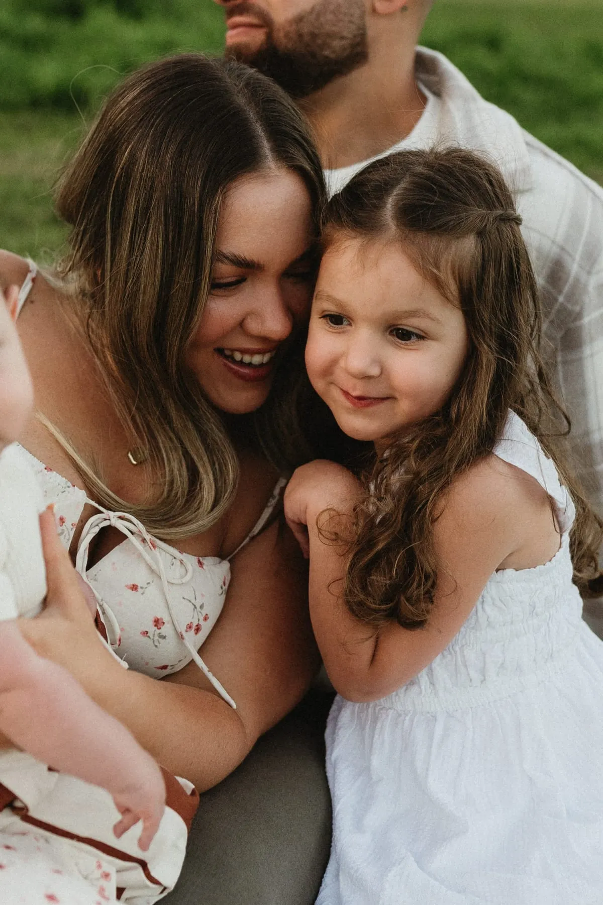 A mum and her daughter cheek to cheek, laughing